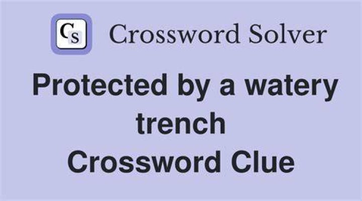Protective trench Crossword Clue